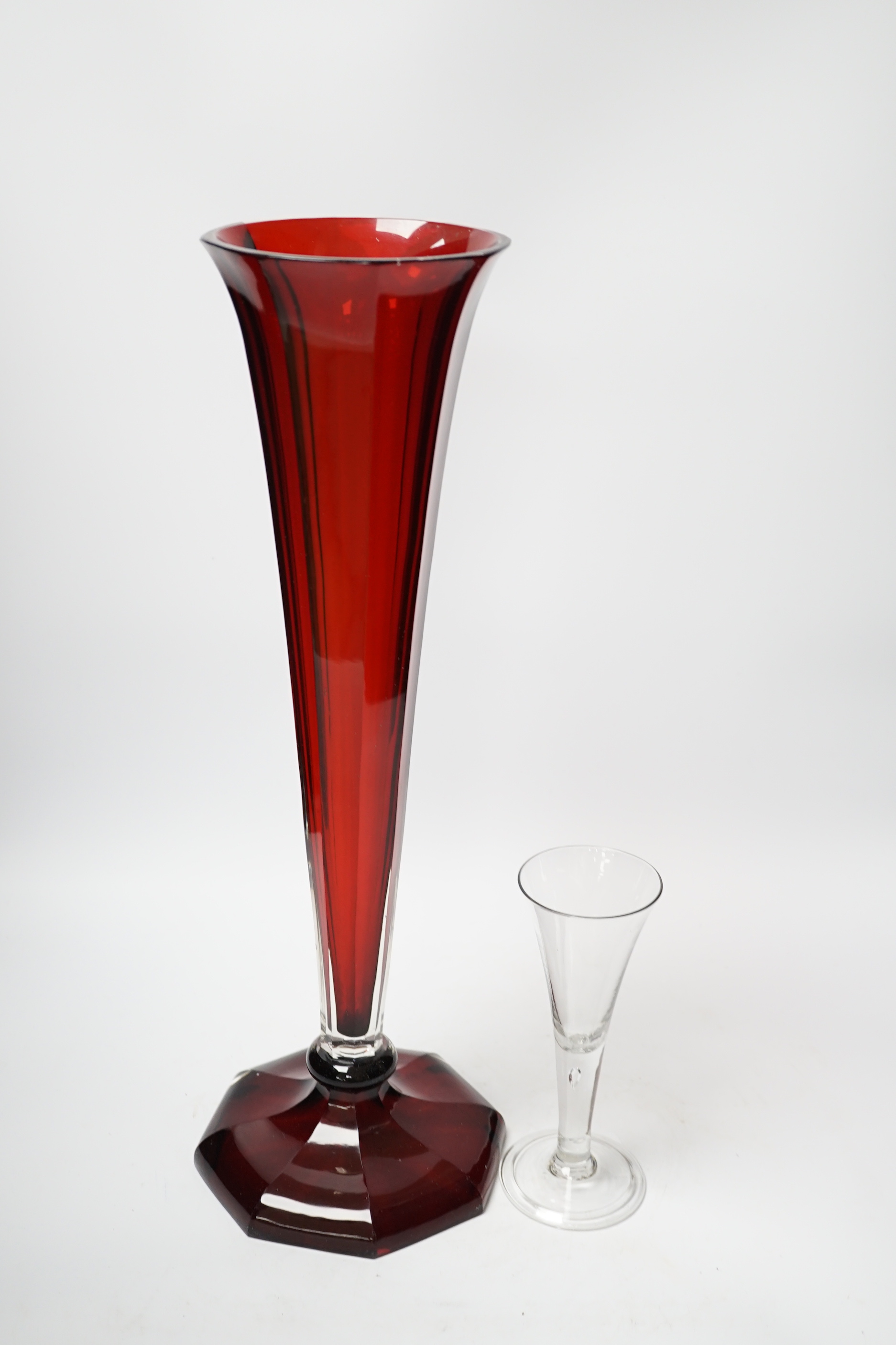 A large Bohemian ruby flashed glass lily vase and a mid-18th century ‘drawn trumpet’ cordial glass with air tear